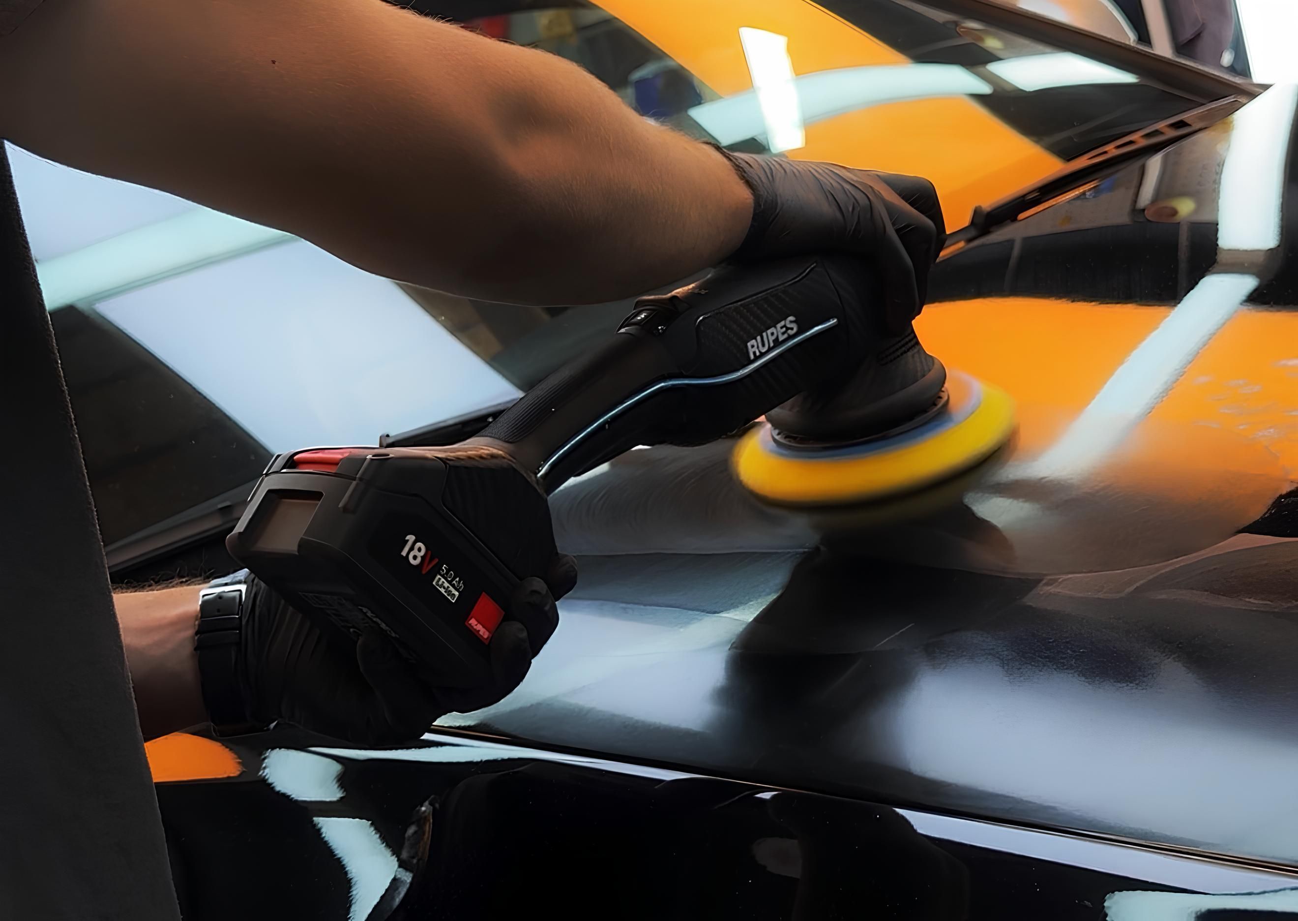 polishing a black car